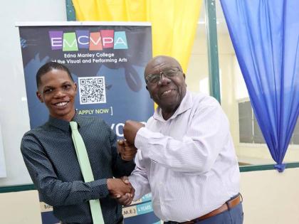 Comedian and cultural icon Oliver Samuels (right) shares a light moment with his foundation’s first scholarship awardee, Dante Saunders, following the handover ceremony.