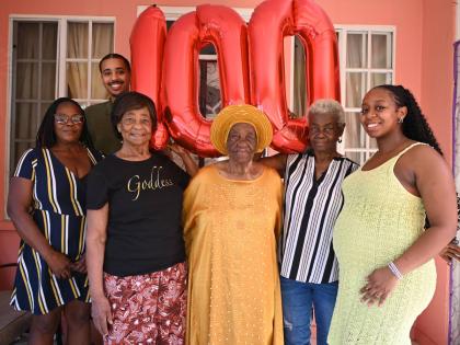 Ethlyn Clarke (centre), of Mt Salem, St James, together with family members and well-wishers on Thursday, following the celebration of her milestone 100th birthday on Tuesday. Also pictured (from left) are Paulette Ricketts, caregiver for Ms Clarke; Tyler 