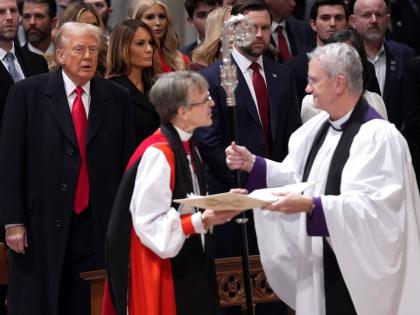 President Donald Trump  watches as Rev Mariann Budde arrives at the national prayer service at the Washington National Cathedral, on Tuesday, January 21, 2025 in Washington. 