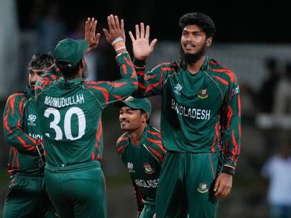 
Bangladesh’s Rishad Hossain, right, is congratulated by teammate Mahmudullah after dismissing Australia’s Travis Head during the ICC Men’s T20 World Cup cricket match between Australia and Bangladesh in North Sound, Antigua and Barbuda, Thursday, Ju