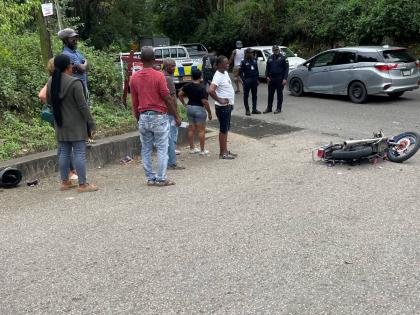 The motorcycle crash scene at Stony Hill main road where two people were injured  yesterday. 