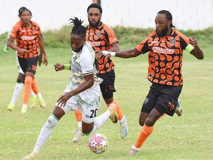 Treasure Beach’s Jhanni Flemmings (second left) looks to outrun Tivoli Gardens FC’s  Keno Simpson (right), Anthony Nelson (second right) and Nickalia Fuller during their rescheduled Jamaica Premier League football match at Edward Seaga Sports Complex o