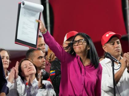 Venezuela's acting President Delcy Rodriguez takes part in a rally holding up a copy of a new law after lawmakers approved legislation opening the nation's oil sector to privatisation, at the Miraflores Palace in Caracas, Venezuela on January 29, 2026. 