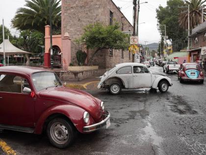 Volkswagen Beetles circulate offering taxi service in the hilly Cuautepec neighbourhood of Mexico City.