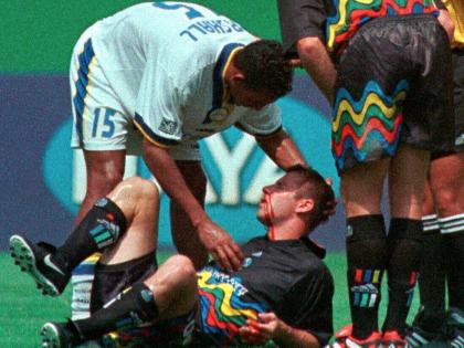 Former Reggae Boy and Miami Fusion’s Tyrone Marshall (15) assists Kansas City Wizards’ Scott Vermillion after the two collided while going up for a header in the first half of a football match on August 29, 1999, in Kansas City, Missouri.