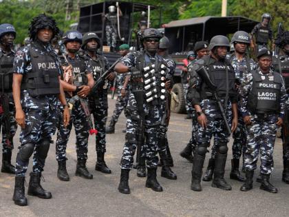  Nigeria police officers stand guard during a candle light procession in honour of all protesters killed nationwide at the recently economic hardship protest, in Lagos, Nigeria, Friday, August 9, 2024. (AP Photo/Sunday Alamba, file)