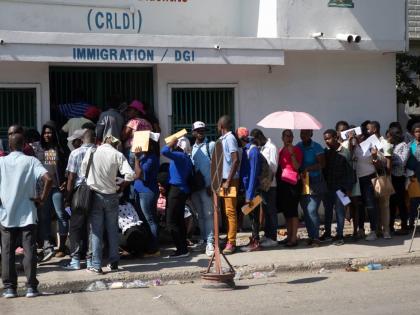 
In this 2023 photo people line up outside an immigration office as they wait their turns to apply for a passport, in Port-au-Prince, Haiti.