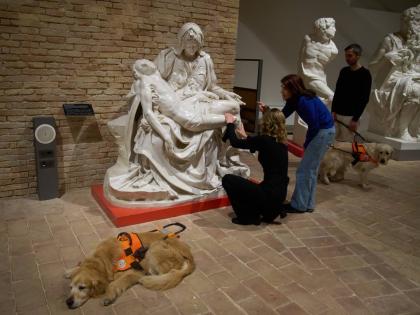 Stefania Terre, left, touches a reproduction of Michelangelo’s sculpture La Pieta with Carmine Laezza, standing at right, during a tour for blind people with Monica Bernacchia, centre, at the Omero Tactile Museum in Ancona, Italy.