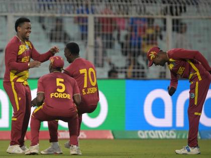 Courtesy of @ICC/X 
Akeal Hossein (right) bows in admiration of Shimron Hetmyer’s (left) brilliant one-handed catch on the boundary to remove a Scotland batter while teammates Matthew Forde (second left) and Shamar Joseph congratulate him during the team