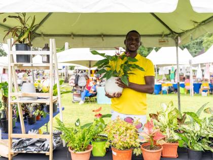 Anand Kumar, owner, Eclipse Florals and Plant Store, at Market on the Lawn in Kingston where five merchants were given the opportunity to display and sell their products by NCB.