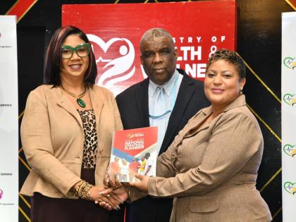 Minister of State in the Ministry of Health and Wellness, Krystal Lee (right), presents a copy of the National Strategic Plan for HIV 2023-2030, to Deputy Coordinator for the Caribbean Regional Programme, United States Embassy in Jamaica, Ava-Gay Timberlak