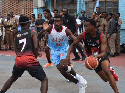Zachery Lawrence-Smith (right) of Campion College dribbles past Imani Salmon (centre) of St George’s College during the ISSA urban Under 19 Basketball finals match at St George’s College on Tuesday.  Looking on at left is Dylon Kelly  from Campion Coll