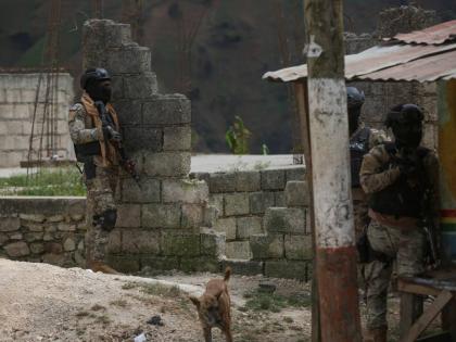 Police officers stand guard during an anti-gang operation in the Kenscoff neighbourhood of Port-au-Prince, Haiti, Monday, February 3, 2025. (AP Photo/Odelyn Joseph)