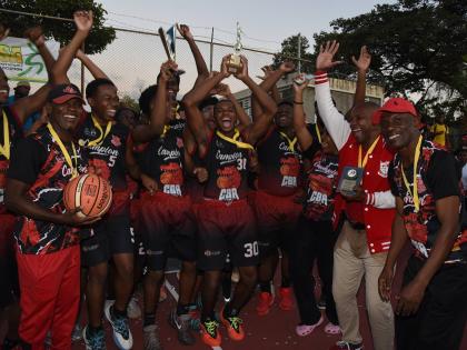 Members of the Campion College ISSA Urban Schoolboys Under-19 basketball team celebrate after they were presented with the championship trophy at the school yesterday.