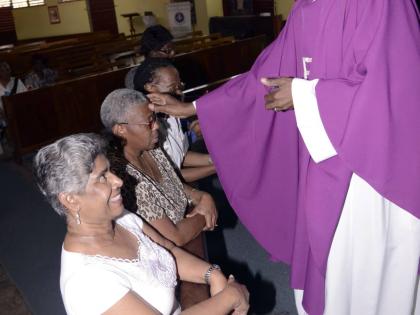 Ven Patrick Cunningham, of St Luke’s church St Andrew, rubbed ash on the forehead of members on  Ash Wednesday, a day of fasting, and the first day of Lent.