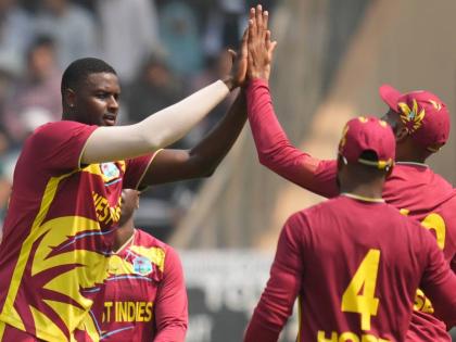  West Indies’ Jason Holder (left) celebrates with teammates after dismissing  Nepal’s Aarif Sheikh during the T20 World Cup cricket match against Nepal in Mumbai, India, on February 15.