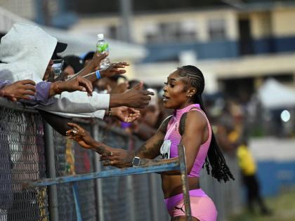  Elaine Thompson Herah greets fans after placing third in the 60 metres at last Saturday’s Camperdown Classic held at Ashenheim Stadium, Jamaica College.