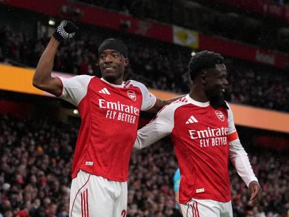 Arsenal’s Noni Madueke (left) and Bukayo Saka celebrate after their side’s first goal during the English FA Cup  match between Arsenal and Wigan Athletic in London yesterday.