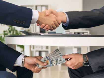 Representational image of bribing.