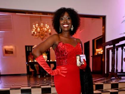 Raising the bar in a red gown is Nadine Spence, managing director of Sixt Rent A Car, who wears a locally designed gown by BrandEd at the annual Sugar Cane Ball.