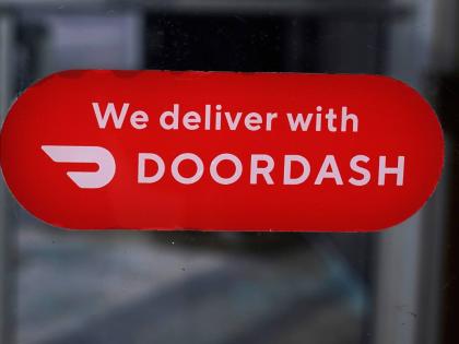 AP
A DoorDash sign is posted on the door of a Dunkin’ Donuts franchise in February 2023 in Methuen, USA.  