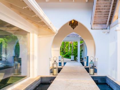 
Islamic arched walkways float over individual pools of water.