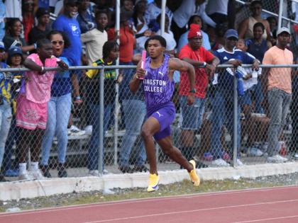 
Kingston College’s Kyle Bodden stretches his legs during the Class 1 4x100 metres at the Corporate Area Athletics Championships at the Ashenheim Stadium, Jamaica College yesterday.