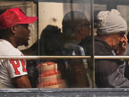 A commuter carries a cake in Havana, Cuba.