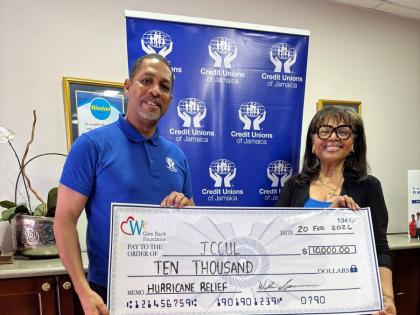  Robin Levy, Group CEO of JCCUL (left), accepts a US$10,000 donation from Judy James, board member of  We Florida Financial Credit Union, to assist Jamaican credit union employees with hurricane recovery efforts. The handover took place on February 20.