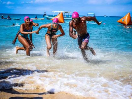 Here, friendly competition meets environmental advocacy as swimmers race for a cause at Swim For The Sanctuary. From left are Isabella Wong of the Tornadoes Swim Club; Emanuelle Spence, also of the Tornadoes, and Brandon Wong of the Y’Speedos Swim Club.