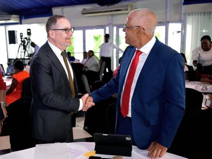 Canada’s High Commissioner to Jamaica, Mark Berman (left), greets portfolio manager for the Caribbean Development Bank (CDB) Basic Needs Trust Fund, George Yearwood, during the opening ceremony for the inaugural Caribbean Civil Society Organisation (CSO)
