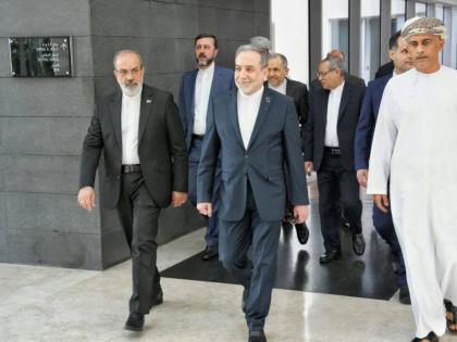 In this photo released by the Iranian Foreign Ministry, Iranian Foreign Minister Abbas Araghchi (centre), heads to the venue for talks between Iran and the US, in Muscat, Oman, Friday, February 6, 2026. 