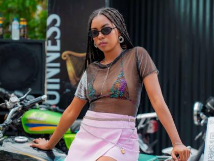 Recording artiste Zhayna is in full Y2K mode, sporting a sheer mesh crop top over a multi-coloured bikini and a light pink mini wrap skirt.