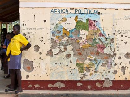 In this photo taken November 15, 2016, students line up outside a classroom with a map of Africa on its wall, in Yei, in southern South Sudan. (AP Photo/Justin Lynch, file)