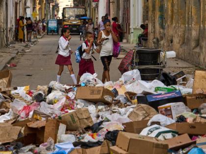People wait to board transportation in Havana, Cuba on February 6, 2026. (AP Photo/Ramon Espinosa)