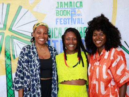Nicole Dennis-Benn (centre), award-winning, bestselling author of ‘Here Comes the Sun’ and ‘Patsy’, who travelled to Jamaica as a featured speaker for the festival, shares a warm moment with Natasha Cunningham (left), visual artist and graphic desi