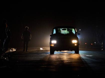 A vehicle drives down a street during a blackout in Havana, Wednesday, March 4, 2026. (AP Photo/Ramon Espinosa)