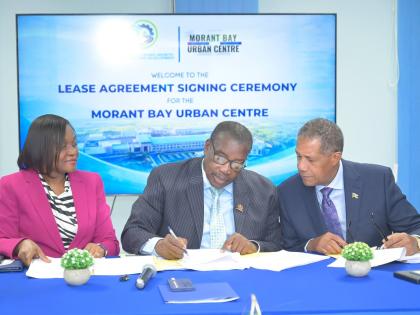 Minister without Portfolio in the Ministry of Economic Growth and Infrastructure Development with Responsibility for Land Titling and Settlements, Robert Montague (centre); Permanent Secretary, Arlene Williams; and Chairman of Morant Bay Urban Centre Li