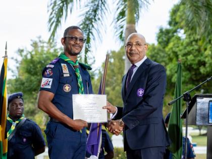 Kevin Richards, chief commissioner of the Scout Association of Jamaica, is receiving his warrant from Sir Patrick Allen, governor-general and chief scout of Jamaica. 