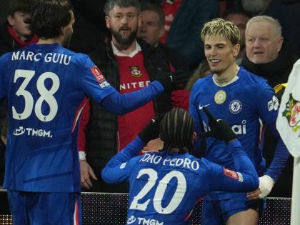 AP Chelsea players, (from left) Marc Gulu, Xoao Pedro, and Garnacho, celebrate after a goal during the fifth round FA Cup football match against Wrexham in Wrexham, Wales, yesterday.