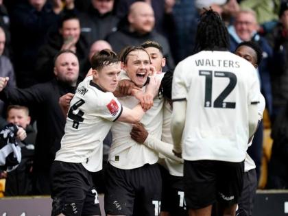 Port Vale’s Ben Waine celebrates with teammates after scoring his side’s first goal of the game, during the FA Cup fifth-round match against Sunderland and Port Vale in Stoke on Trent, England, yesterday.