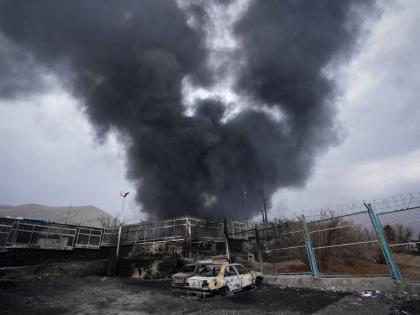 A thick plume of smoke rises from an oil storage facility hit by a US-Israeli strike in Tehran, Iran on March 8, 2026.