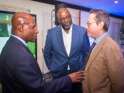 Minister of Industry, Investment and Commerce, Senator Aubyn Hill (left), engages in discussion with Acting Chief Executive Officer of the Jamaica Business Development Corporation (JBDC), Harold Davis (centre), and Deputy Head of Cooperation at the Europea