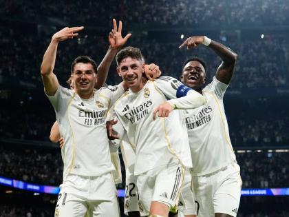 Real Madrid’s Federico Valverde (centre) celebrates after scoring his third goal during a first-leg round-of-16 Champions League football match against Manchester City in Madrid, Spain, yesterday.