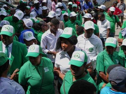Members of the EDE (Committed to Development) political party arrive to register the party at the Provisional Electoral Council in the Petion-Ville neighborhood of Port-au-Prince, Haiti on March 12, 2026. (AP Photo/Odelyn Joseph)
