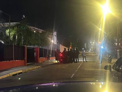 Investigators surround a Honda Fit motor car following a fatal shooting on Ruthven Road in St Andrew on March 12, 2026. 