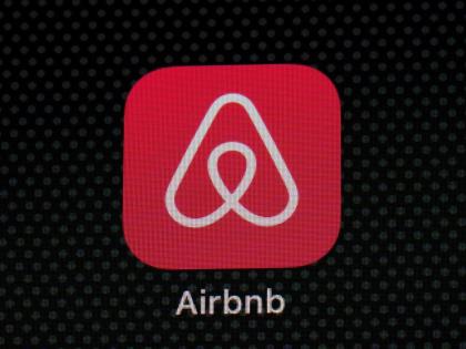 The Airbnb app icon is displayed on an iPad screen.