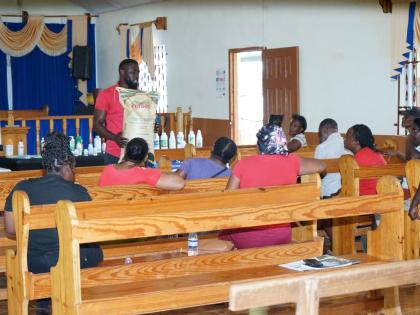 Akeem Williams, technical sales consultant at Newport-Fersan Jamaica, addresses ginger farmers during a training session on preventing and treating rhizome rot on Wednesday. 