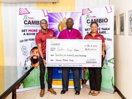 Romario Creary (left), head of FX Trader Cambio and Calecia Robinson, FX Trader’s marketing manager, flank Bishop Leon Golding of the Diocese of Jamaica and the Cayman Islands, operators of the Clifton Boys’ Home.