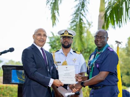 Garth Russell (left), former chief commissioner of the Scout Association of Jamaica, receives his Silver Crocodile Award from Sir Patrick Allen, governor general and chief scout of Jamaica. The award is presented to scouters who have rendered outstanding a
